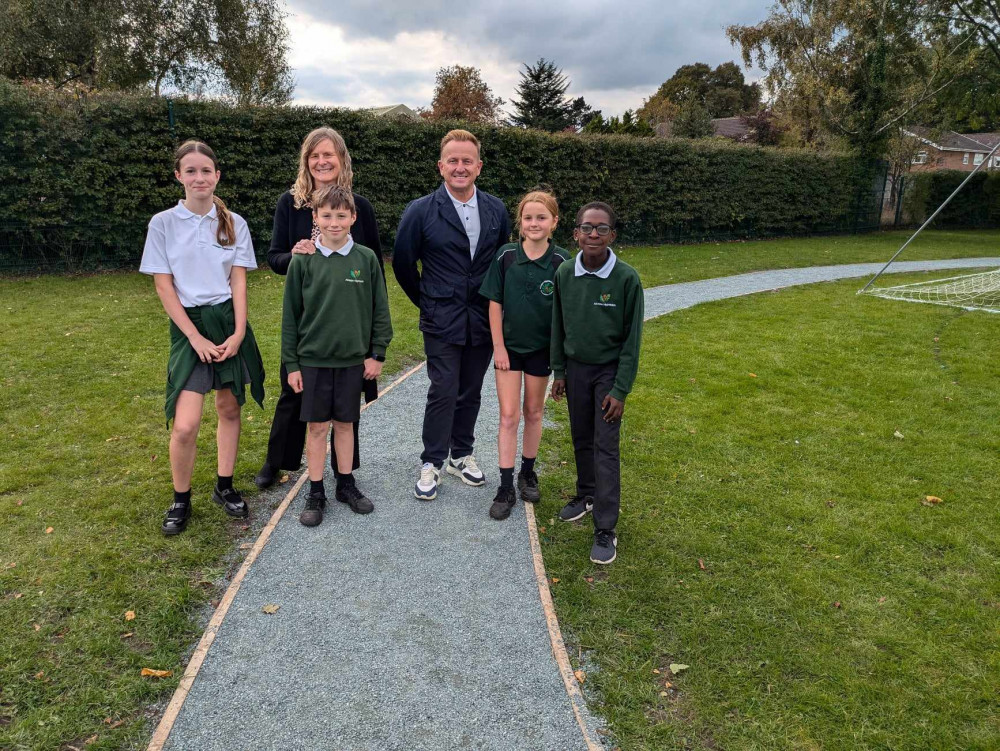 Alsager businessman, Ian Donaldson, with headteacher Rachel Woollam and pupils on Alsager Highfields Primary School's new 'daily mile'. (Photo: Nub News) 