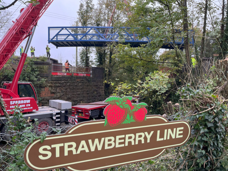 The 15-metre bridge, as long as a double-decker bus, being craned into place over the B3136 in Shepton Mallet as part of the Strawberry Line project (Submitted) 
