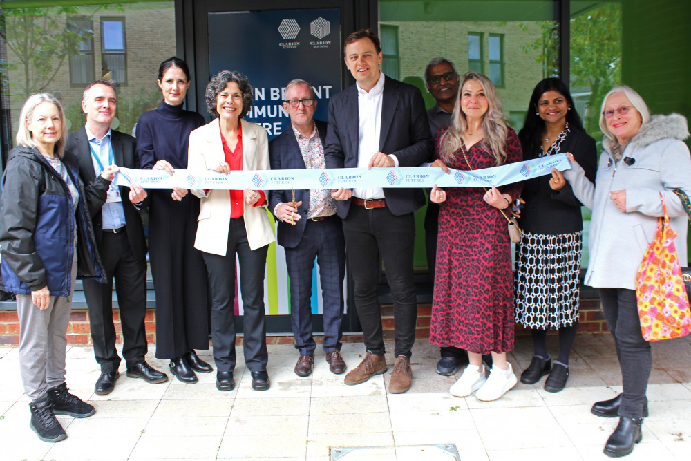 Sherwood Close resident, Jerry, holding the scissors during the ribbon cutting ceremony of the Colin Bryant Centre with members from Ealing Council and Clarion Housing (credit: Clarion Housing Group).