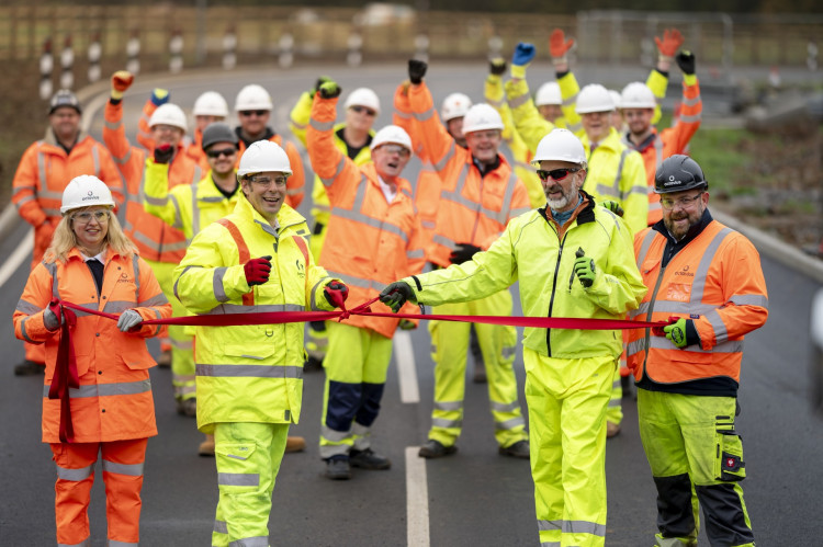 Opening the new junction - Nick Brooks, ORCE Contracts Manager and Ewelina Gregorczyk, ORCE Assistant Project Manager with Cllr Richard Wilkins and Somerset Council and ORCE teams in the background.