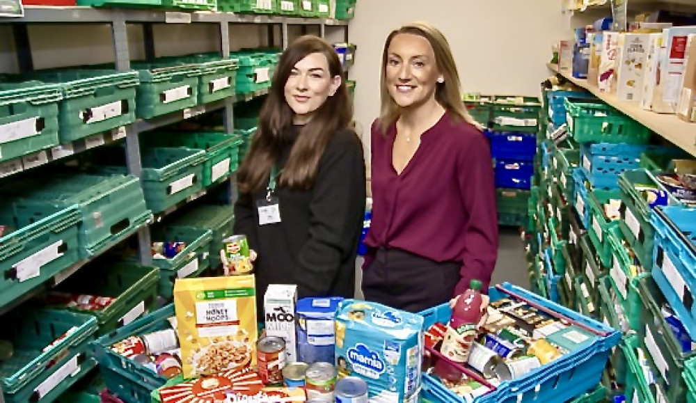 Jade Desombre, Manager of Coalville Foodbank, and Emma Bexon, Area Sales Manager for Davidsons Homes, with some of the food purchased for people in crisis. Photo: Supplied