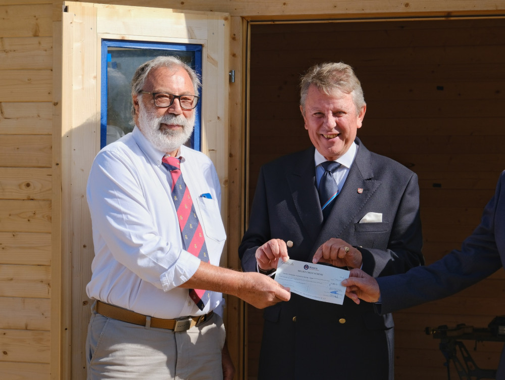 Robert Heath, treasurer of Twickenham Lodge presented a cheque to David Allan, President of HKWR (image supplied)