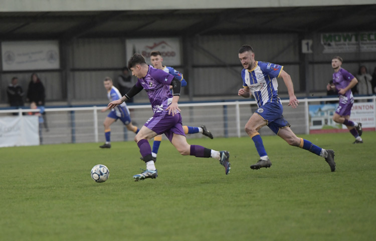 Callum Gould (No. 8 in purple) on the ball for Shepton, moments before scoring the equalising goal against Clevedon. (Colin Andrews) 