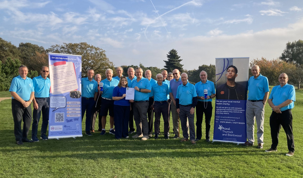 Orsett Vets Captain David Pavitt is seen presenting the donation to Donna Marshall from TBMind, at Orsett Golf Club, accompanied by some of the other members of the Orsett Vets dressed in their Aqua Blue team shirts.