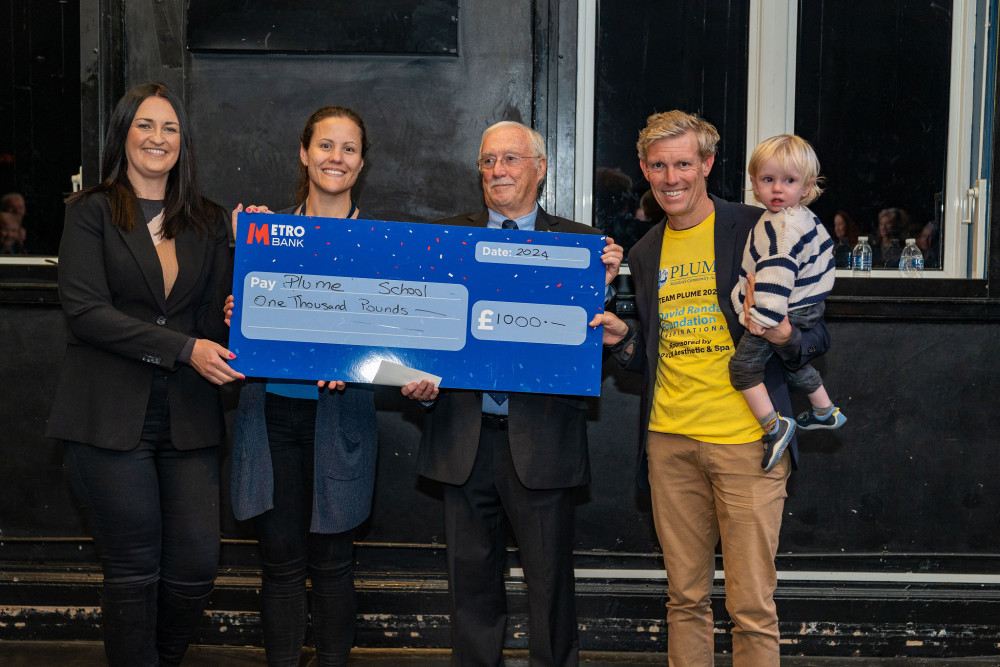 Plume School received a cheque for £1000, collected by Maldon Mud Race 2024 winner and Plume staff member Peter Carlsson (Credit: Helen Anderson Photography @helenandersonphotography)