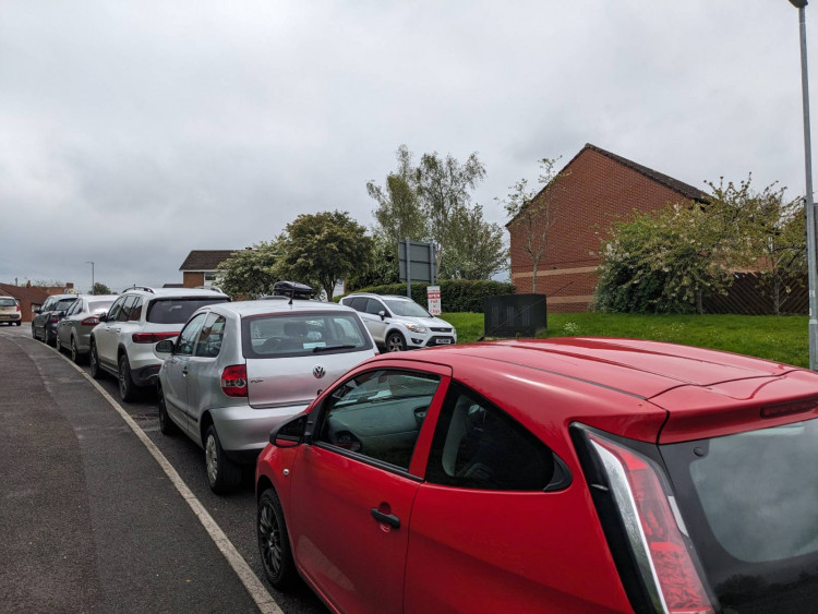 Cars parking in residential streets before carnival in Glastonbury (LL) 