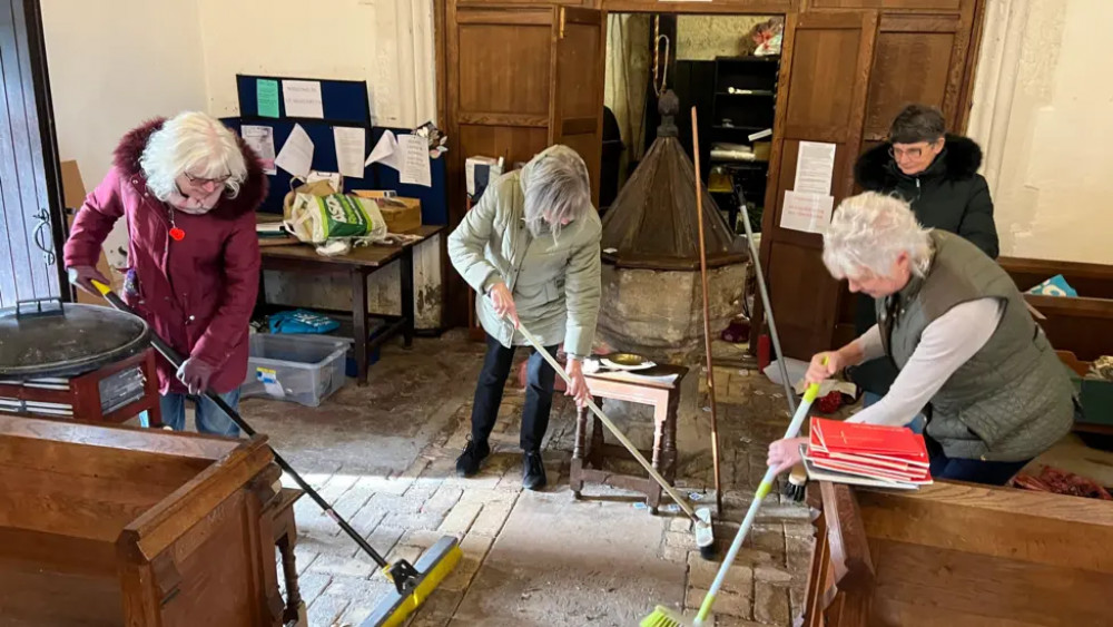 Church members clearing up after the attack. Picture Sturat Woodward (BBC).