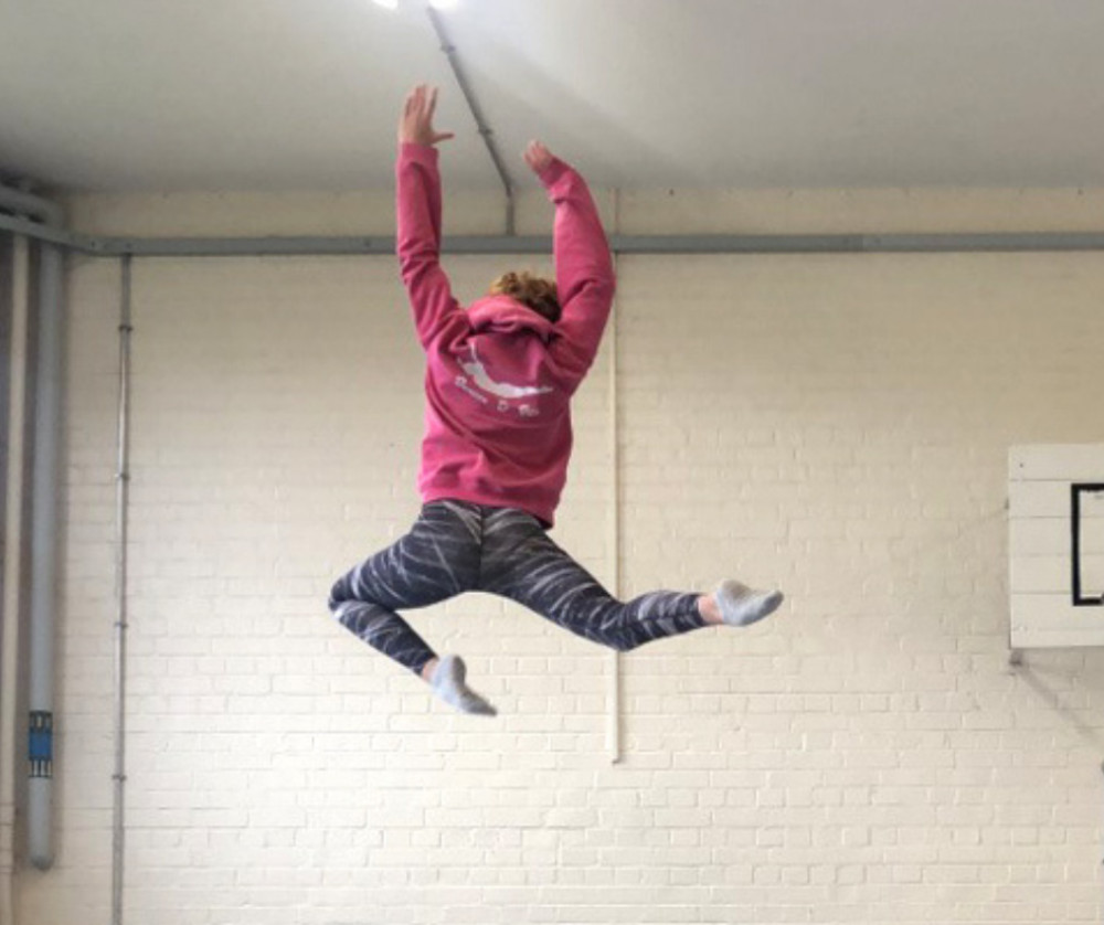 A young gymnast bounces into action on the trampoline at Bounce & Flex