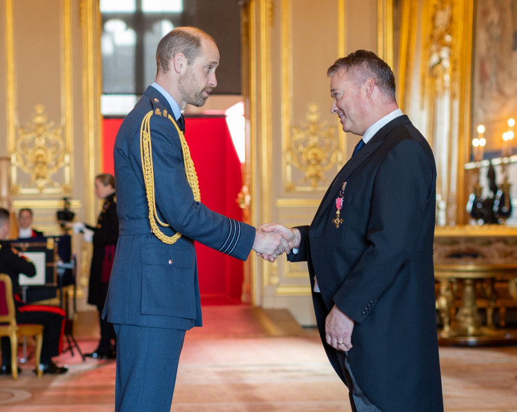 Ed Russel shakes hands with Prince William after receiving his OBE (image supplied)