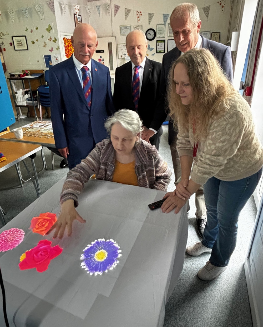 Watching a Heads Up client enjoy the Magic 360 video table are, from  the left, Mark Master Masons Val Cooke, Robert O’Malley-White and Philip Voisey with Michelle Payne