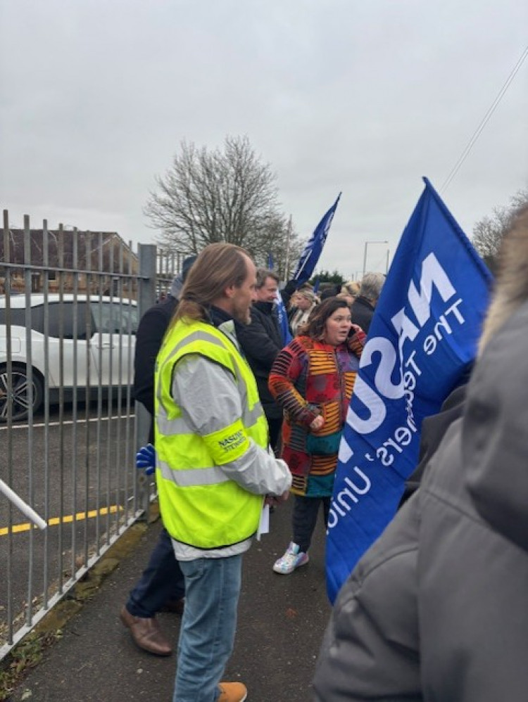Parents and teachers outside the school gates. 