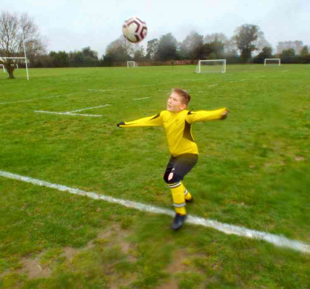 Hornets under-nine player Bobby Warner shows how to head a ball