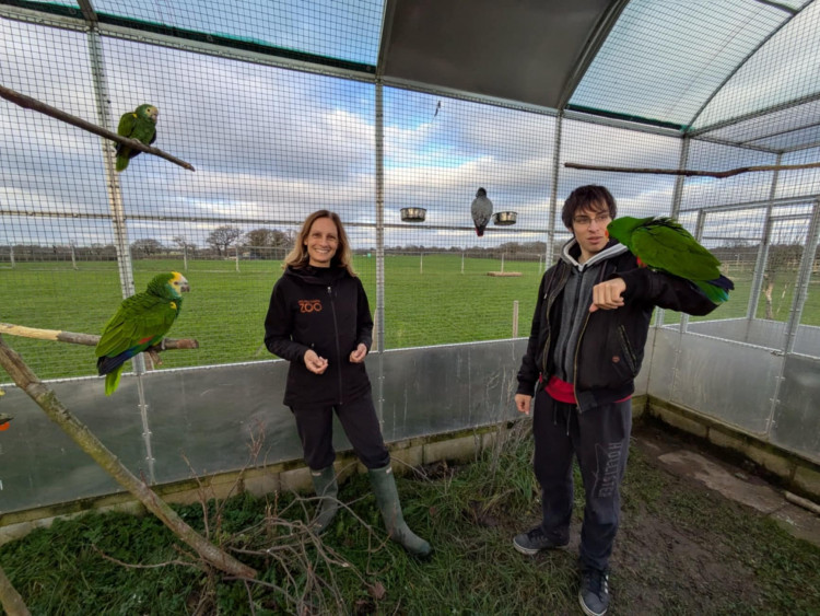 Melissa Mews and son Edmond, site manager, with the parrots. (Photo: Nub News)