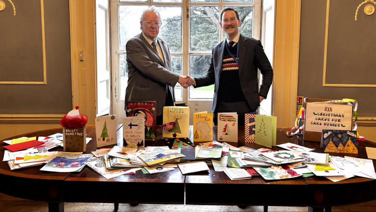 Philip Welch, left, collects the first batch of cards from Alastair Tighe