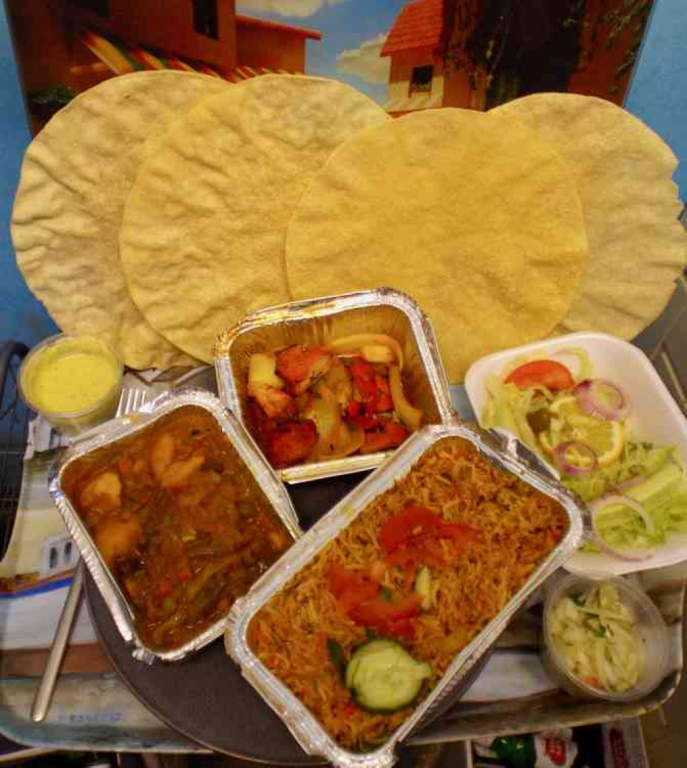 Lasan tikka, prawn biryani, poppadoms, mint sauce and salad