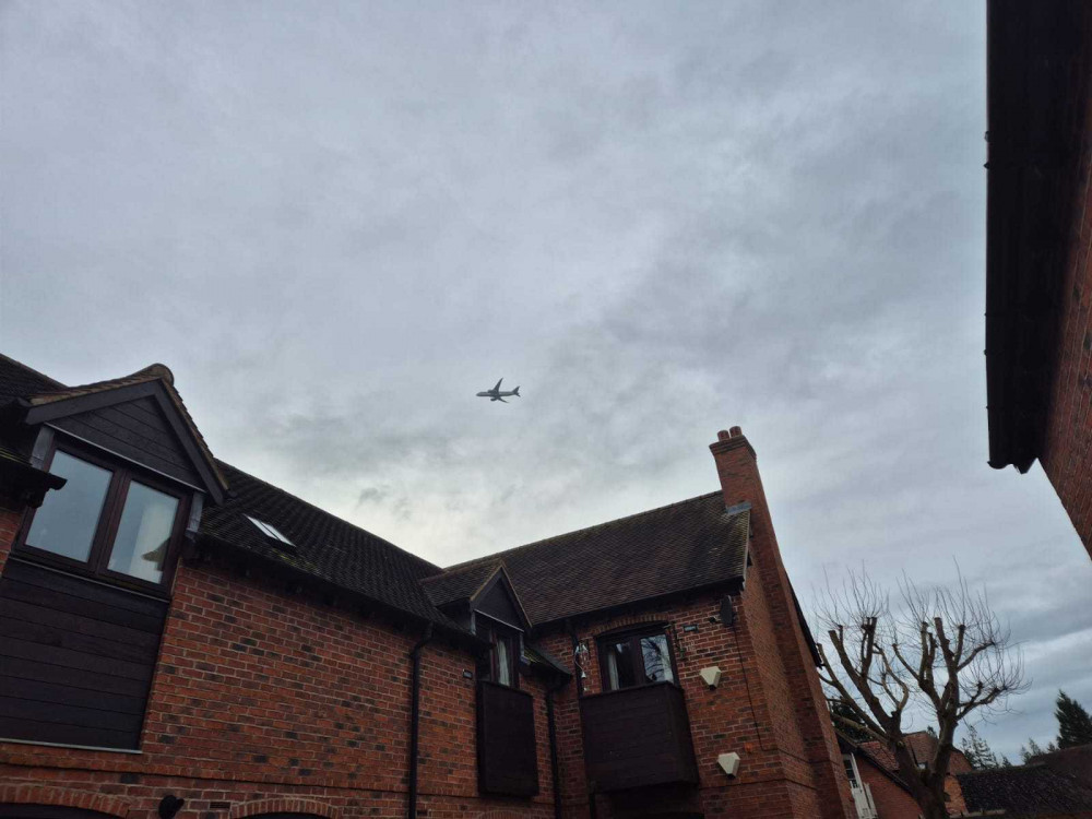 A plane flies over houses in Hampton-in-Arden (image via LDRS)