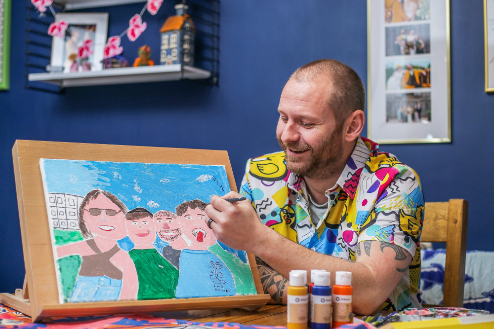 Jamie Lee Matthias with his paintings at his home in Alsager. (Joseph Walshe / SWNS) 