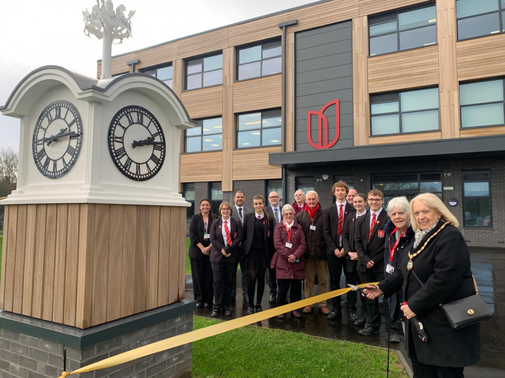 Deputy mayor Sue Shinnick, flanked by former councillor Joy Redsell and staff and students at Orsett Heath Academy, cut a ribbon to mark the clock's placement at the new school