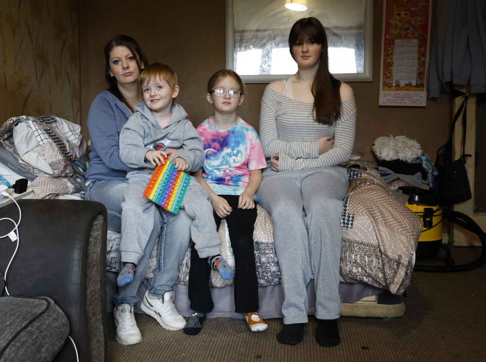 Stacey holding Hunter, 4, next to Bella, 8, and Leona, 14 - (credit: Facundo Arrizabalaga/MyLondon).