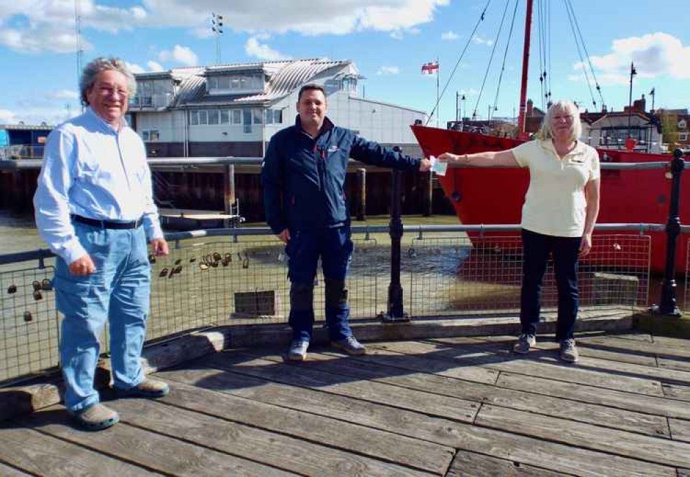 Phill Barnes, Commodore of Shotley Point Yacht Club, and his wife Sheila present a cheque for £1,200 to Neal Sandquest, Coxswain of the Harwich RNLI lifeboat.