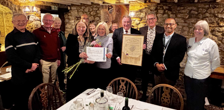 Mary Ellis and guests at their 50th anniversary dinner with their framed charter and the certificate of celebration and recognition   Picture: Philip Welch