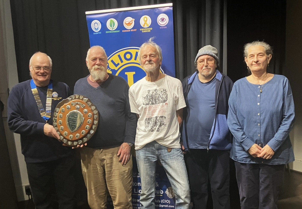 Lion President Derek Green presenting the Brains of Avalon Trophy to the members of the winning team, Forum (Supplied) 