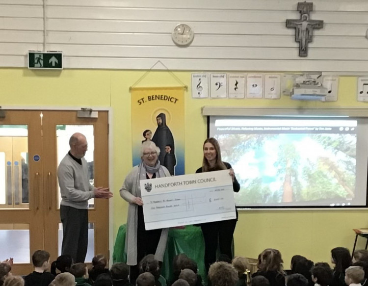 Cllr Susan Moore, Chair of Handforth Town Council, presented the cheque for £2000 to the school at an assembly (Handforth Town Council).