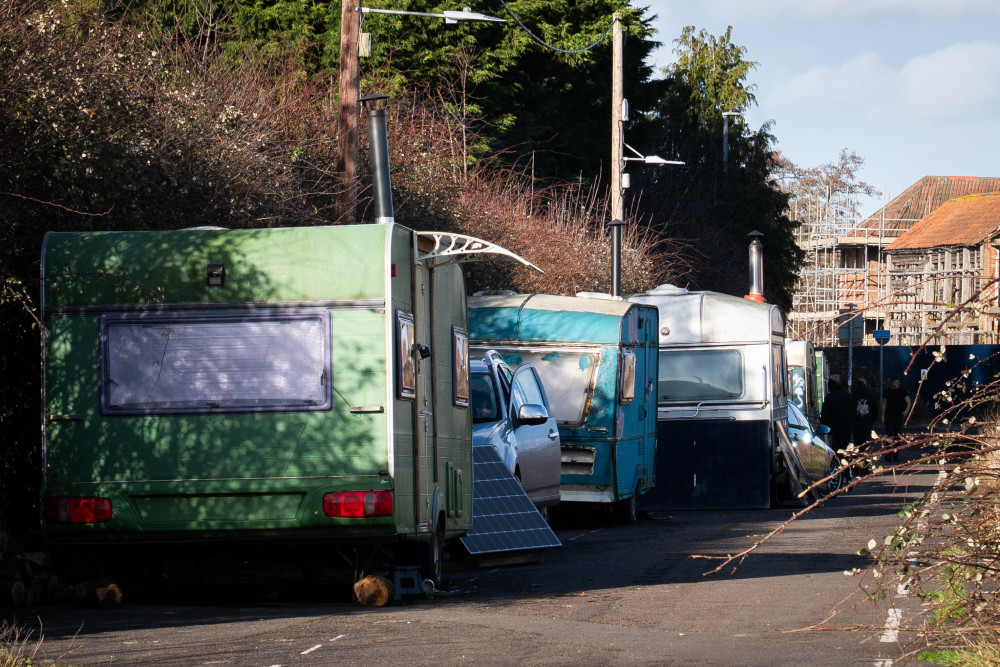 A national report highlights Glastonbury tensions between residents and van dwellers, citing waste, crime, and concerns over insufficient local support.