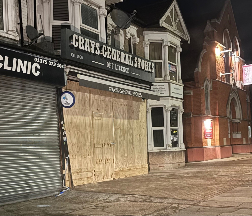 The boarded up shop frontage. 