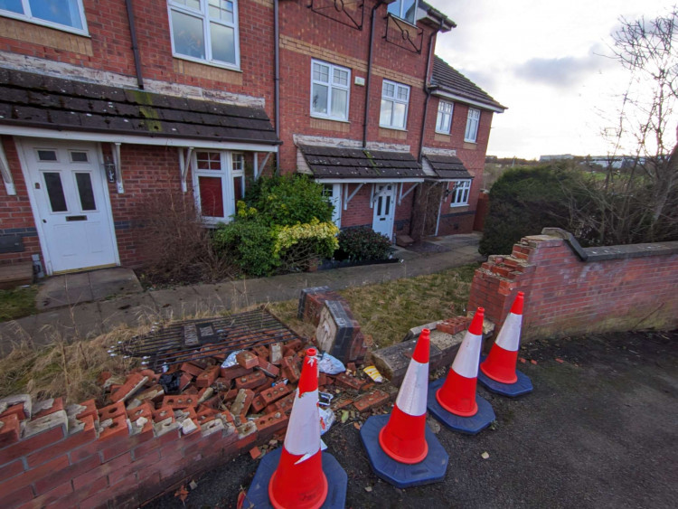 The damaged brick wall on Rolls Avenue, near Chassagne Square, remains in a 'dangerous' and 'unsightly' state, says Crewe St Barnabas councillor, James Pratt (Nub News).