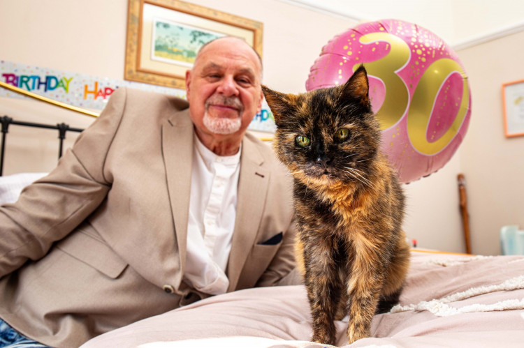 Leslie Greenhough from Stockport is celebrating the 30th birthday of Millie, his cat who he believes is the oldest living feline (Image via SWNS)