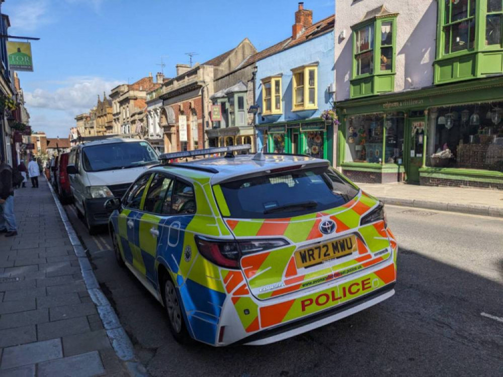 A police car on patrol in Glastonbury High Street following incidents in the town and nearby Street.