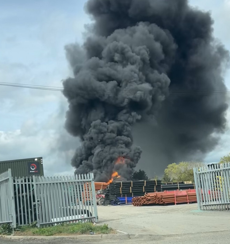 The fire at the green belt industrial site caused a huge plume of smoke.