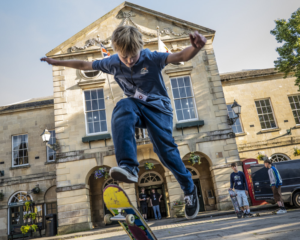 A young skateboard enthusiast outside Wells Town Hall, celebrating the launch of the Wells Skatepark Project crowdfunder A young skateboard enthusiast outside Wells Town Hall, celebrating the launch of the Wells Skatepark Project crowdfunder