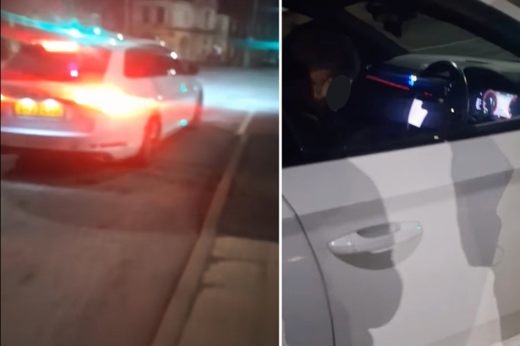 The two officers were filmed 'asleep' in a car in Fenton on February 10. (Levi Brown)