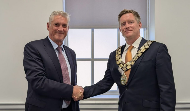 Cllr Kenny Horn presents Measham councillor Paul Lees with the chain of office. Photo: NWLDC