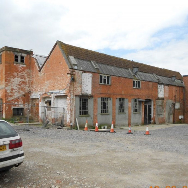 The £3 million Life Factory project in Glastonbury is halted due to financial mismanagement and unpaid contractors. 