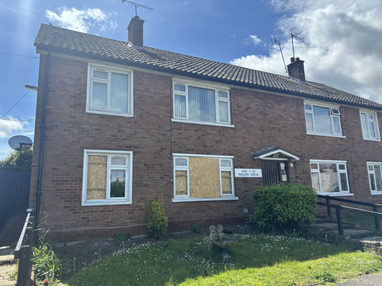 Boarded up windows after police raid on Phillips House.