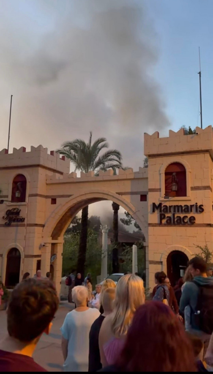 Smoke rises above the hotel.