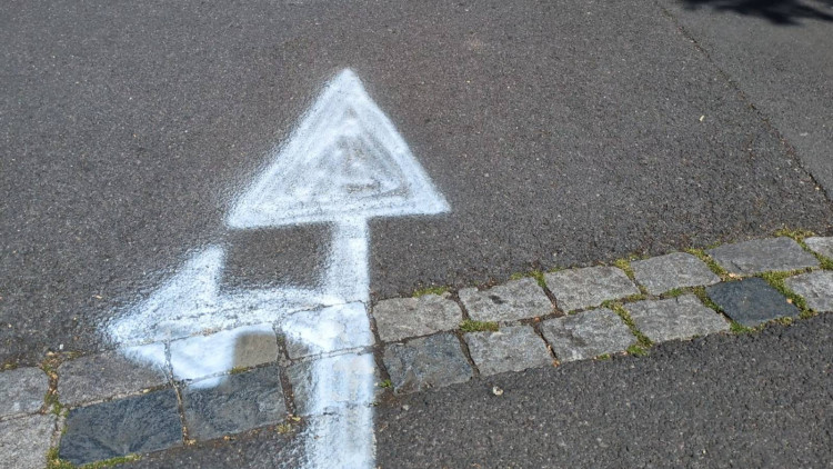 A mysterious local has repainted faded directional markings in Glastonbury's St John's Car Park, an area neglected by Somerset Council. (LL/DILY)
