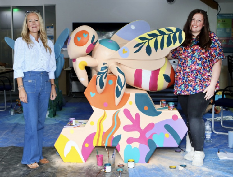 Claire Perry from Manuka Doctor and artist Charlie Stafford with the ‘hive of hope’ giant bee. (Credit: Farleigh Hospice)