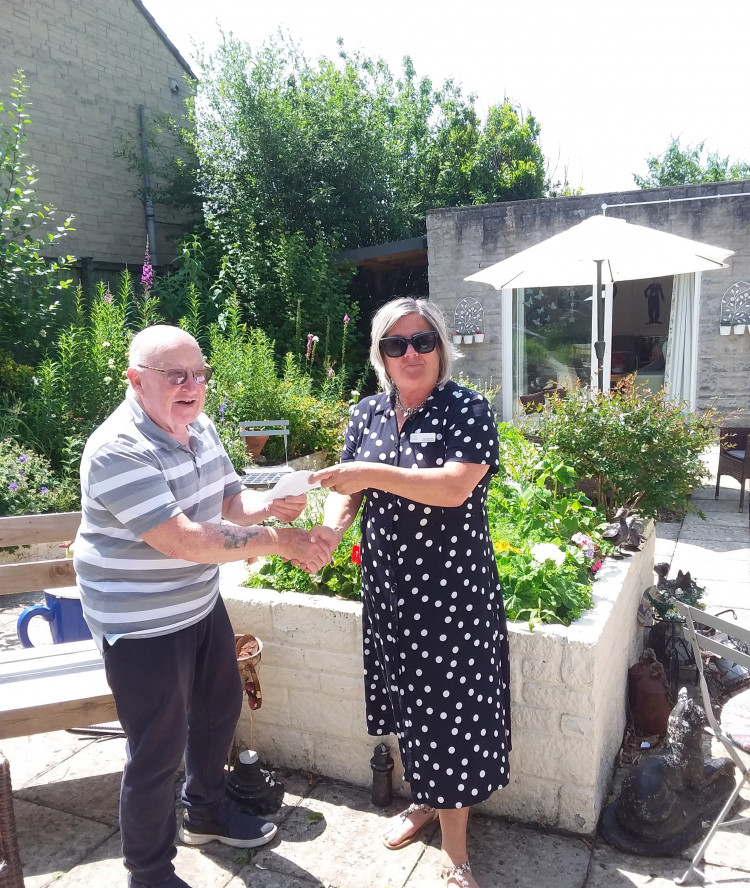 St Cecilia manager Tracy Woolfrey presenting Pete Dalgarno with the £100 voucher from Saputo Dairy UK Limited. 