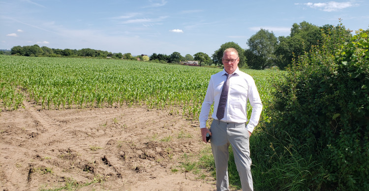 Chelford parish councillor Mark Shepherd at the access to the field where the housing estate is proposed off Knutsford Road at Chelford (Credit: LDRS)