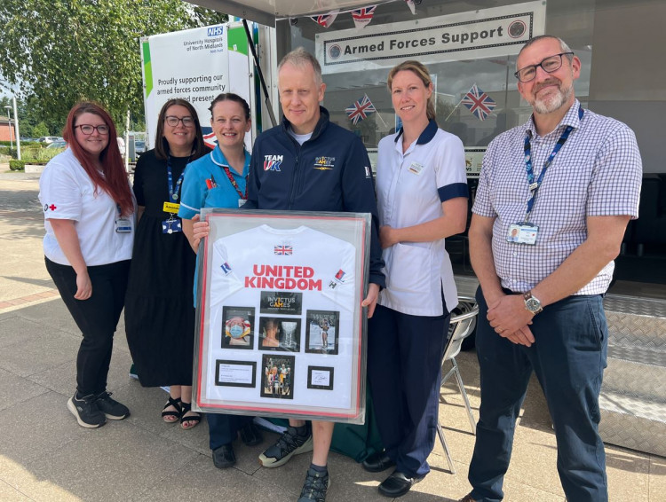 Rob Shenton presenting his Team GB kit to staff at the Royal Stoke. (UHNM)
