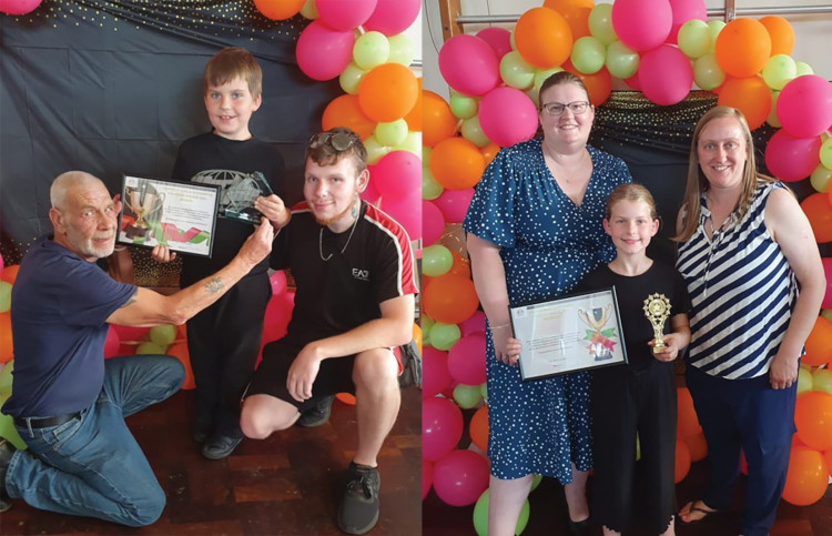 Award winners Zach and Chloe with their families.