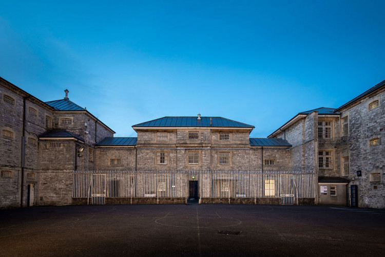 The iron gates at Shepton Mallet Prison are closing once again – but this time, the inmates are CEOs, consultants and councillors from across Somerset and Dorset.  It’s all part of Jail or Bail, a tongue-in-cheek challenge to raise cash for Dorset and Somerset Air Ambulance – and this year’s line-up of unlucky “prisoners” has just 24 hours to secure their release.  Their crimes? Questionable office habits, chocolate-related offences and a suspicious fondness for cheese. The punishment? A night in Britain’s oldest prison, complete with gruelling chores, ghost tours and escape rooms.  Each inmate has been handed a bail target of £800 – and they’ll need the public’s help to raise it if they want out.  Leading the charge is Charles Hackett, chief executive of the air ambulance charity itself – banged up for “being way too choosy about the office tea.”  Joining him are:      Helen Haxell, principal consultant at AxeSharp Communications – “Loves ghosts by day, terrified by them at night.”      Jason Fewell, engineering boss at Wyke Farms – charged with “cheese theft, drink smuggling and DJ-ing disasters.”      Mark Bolton, principal of Yeovil College – “Too energetic and helpful – makes the rest of us look bad.”      Joseph Hughes and Mark Chugg from Greenslade Taylor Hunt – guilty of “too much sarcasm” and “mug drama.”      Paul Dunlop, Blanchards Bailey LLP – “Being a lawyer – say no more.”      David Crew, Somerset Chamber of Commerce – “Office chocolate hat neglect.”      Cllr David Woan, Somerset Council – “Excessive enthusiasm.”  The event kicks off on Thursday 10 July, and from midday, the nine will be locked inside Shepton’s infamous slammer until they hit their bail target.  The public are being urged to chip in, cheer them on, or share their story online to help the group hit their fundraising goal – and escape the cellblock.  The Dorset and Somerset Air Ambulance team will be sharing updates as the drama unfolds – including footage of chores, ghost hunting and prison life – so get ready to follow along on social media.  Because while the crimes might be fake, the cause is very real – and every penny raised helps keep this vital emergency service in the air.