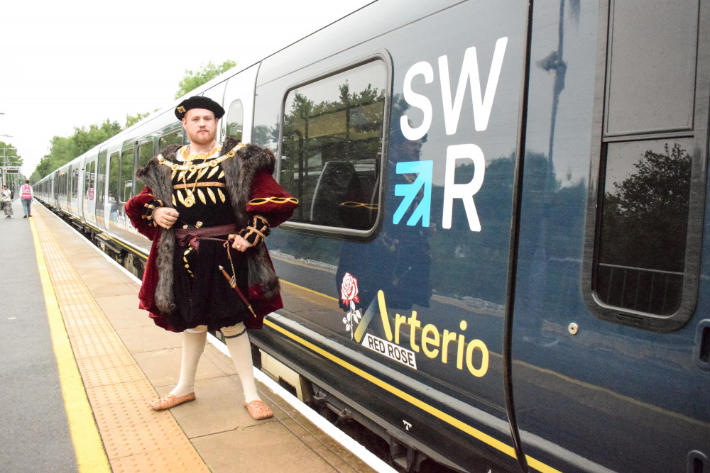 King Henry VIII swapped his barge for a South Western Railway train to celebrate 35 years of the RHS Hampton Court Garden Festival (credit: SWR). King Henry VIII swapped his barge for a South Western Railway train to celebrate 35 years of the RHS Hampton Court Garden Festival (credit: SWR).