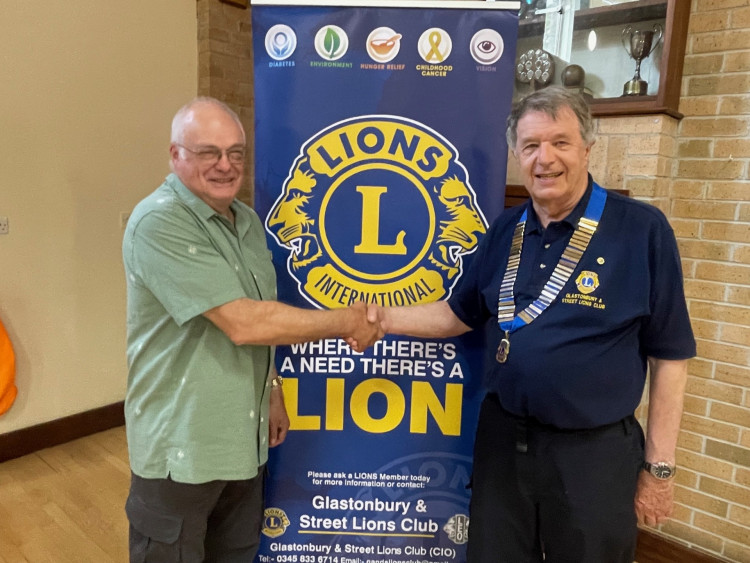 Outgoing President Lion Derek Green hands-over to the new President, Lion Peter Cole  (Supplied) 