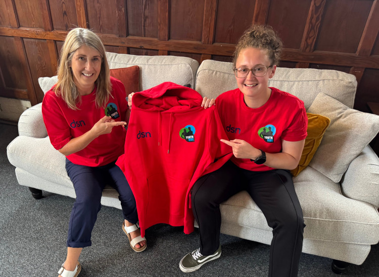 DSN Youth Worker with Senior Practitioner Georgia Middlehurst showing their new uniforms at Chester Deaf Club (Image via: Cheshire Deaf & Sensory Network)