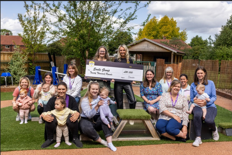 Omaze's Natasha Walker presents the cheque to Smile Group's co-founder Ruth Williams (Credit: Omaze)